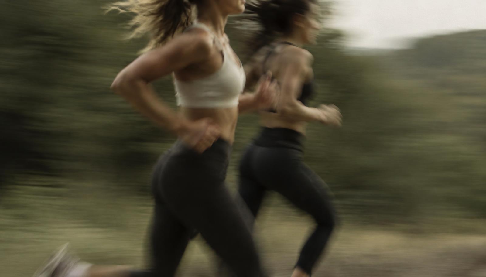 Two athletes training together, captured with motion blur